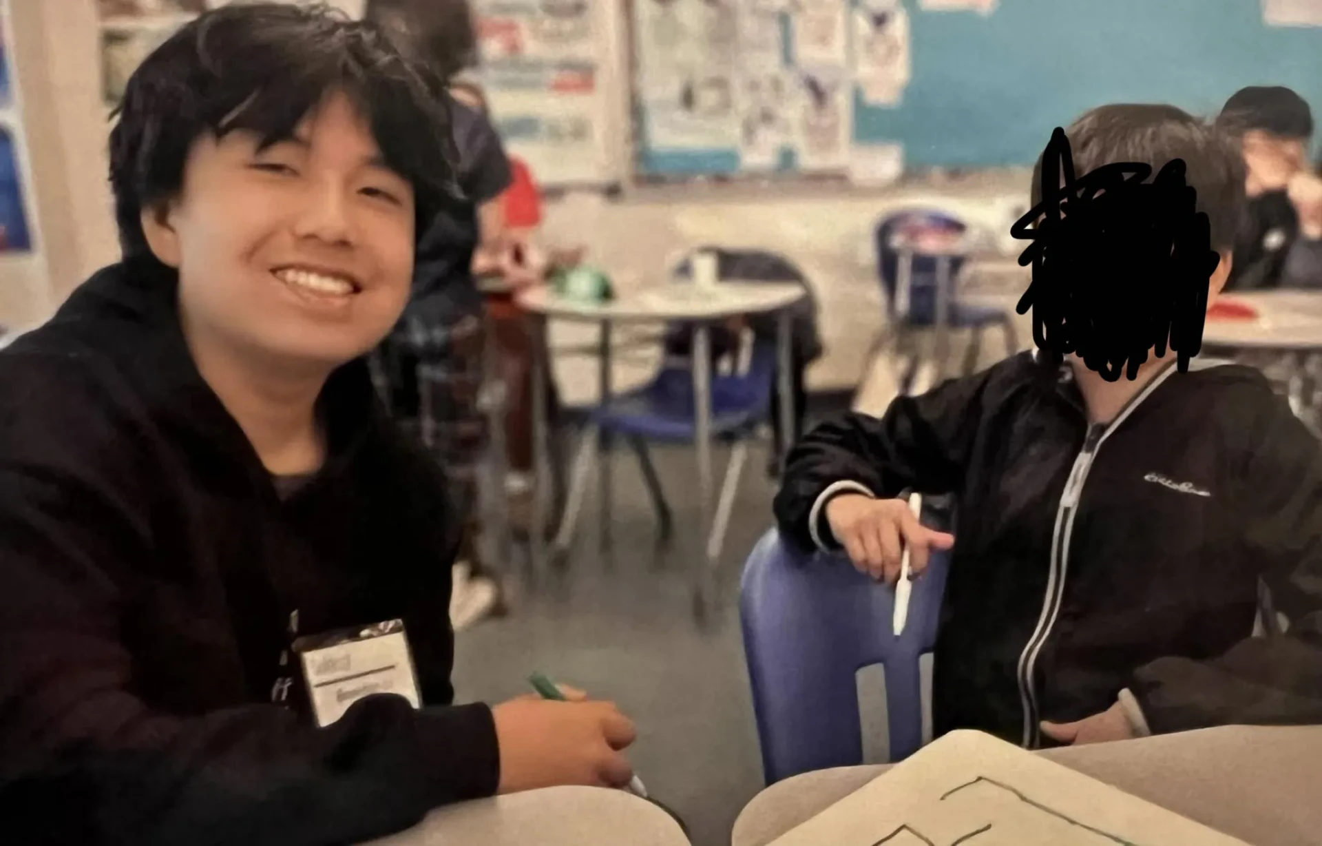 Brendan supporting a student during a youth workshop