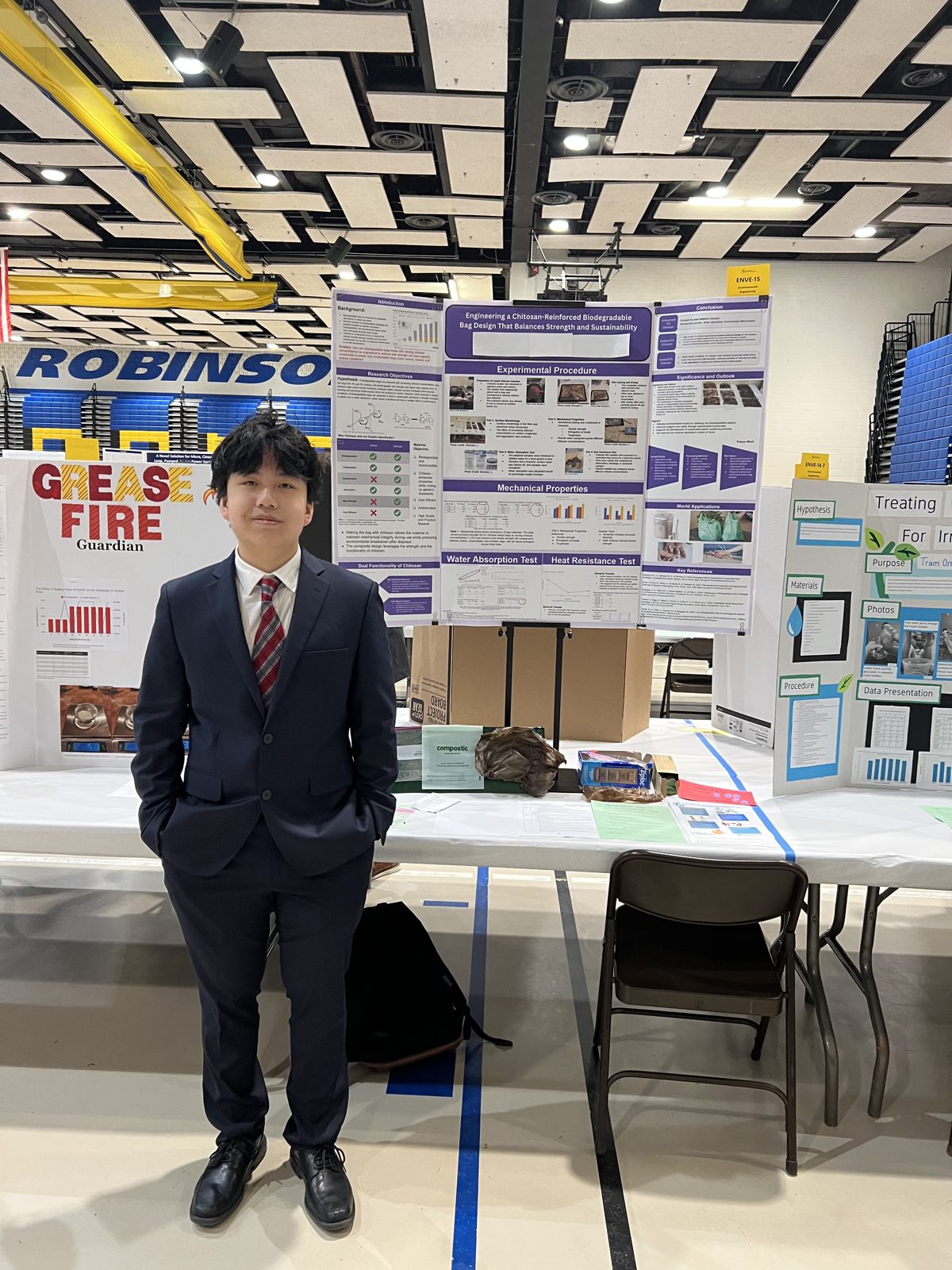 Brendan beside his science fair display board