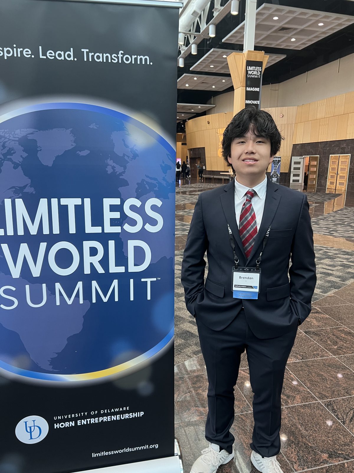 Brendan beside the Limitless World Summit banner